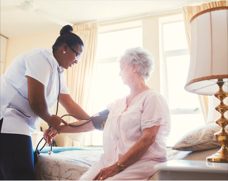 nurse taking a blood pressure into an elder woman